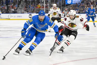 Oct 15, 2025; St. Louis, Missouri, USA; St. Louis Blues defenseman Justin Faulk (72) controls the puck as Chicago Blackhawks defenseman Wyatt Kaiser (44) defends during the third period at Enterprise Center. Mandatory Credit: Jeff Curry-Imagn Images