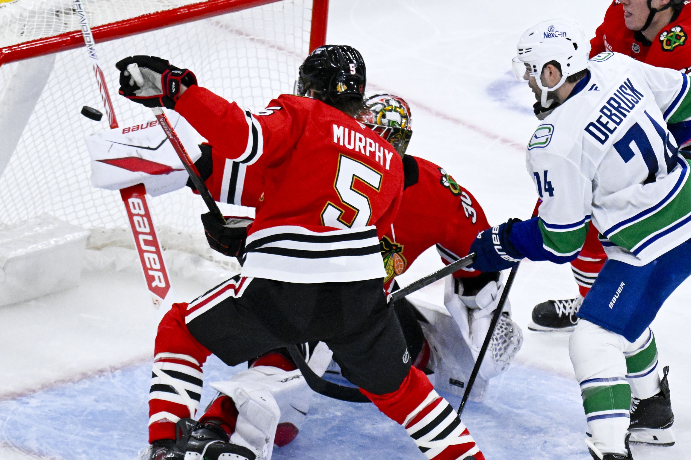 Vancouver Canucks left wing Jake Debrusk (74) scores past Chicago Blackhawks
