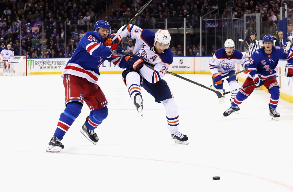 Vladislav Gavrikov (left) slows up Leon Draisaitl during the third period of the Rangers' loss to the Oilers.