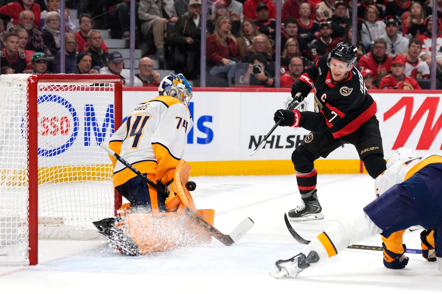 Predators goalie Juuse Saros makes a save on the Senators' Brady Tkachuk in the second period Monday night. Tkachuk was injured in the first period but stayed in the game until leaving in the third period.
