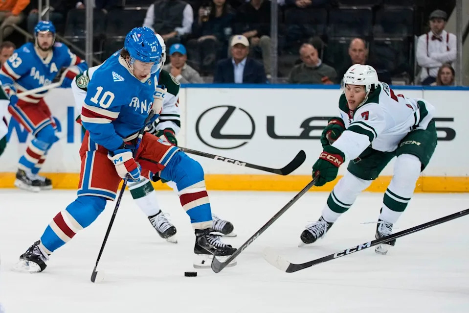 Brock Faber defends against Artemi Panarin during the Rangers’ loss to the Wild on Oct. 20, 2025. AP