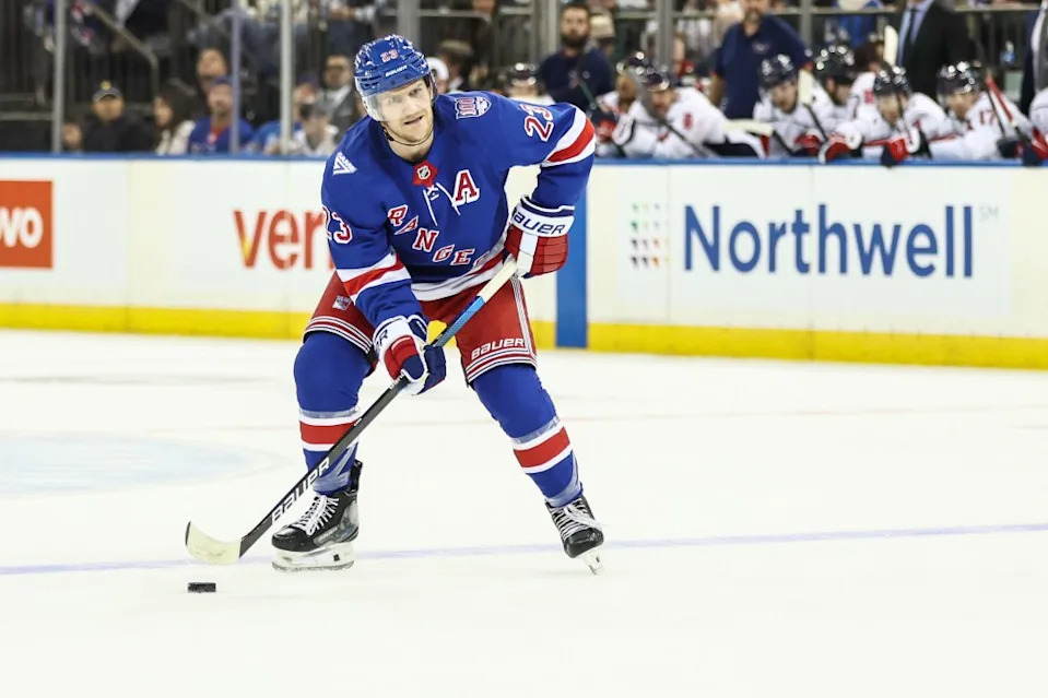 New York Rangers defenseman Adam Fox (23) looks to make a pass during a power play in the second period against the Washington Capitals at Madison Square Garden. Wendell Cruz-Imagn Images