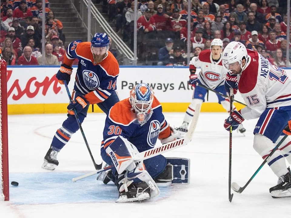 Montreal Canadiens’ Alex Newhook (15) scores on Edmonton Oilers goalie Calvin Pickard (30) as Mattias Ekholm (14) looks on during first period NHL action, in Edmonton on Thursday, October 23, 2025.