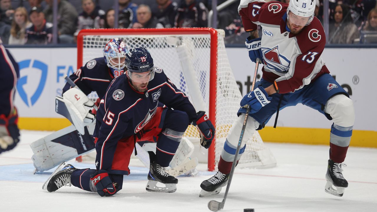 Colorado Avalanche forward Valeri Nichushkin, right, controls the puck in front of Columbus Blue Jackets defenseman Dante Fabbro, center, and goalie Elvis Merzlikins, during the second period of an NHL hockey game in Columbus, Ohio, Thursday, Oct. 16, 2025.