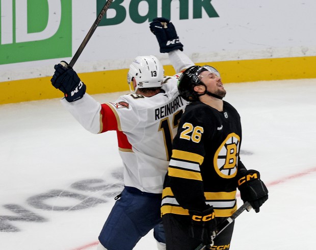 Sam Reinhart (13) of the Florida Panthers celebrates the game-winning goal as Andrew Peeke (26) of the Boston Bruins shows frustration during the third period at the TD Garden. (Photo By Matt Stone/Boston Herald)