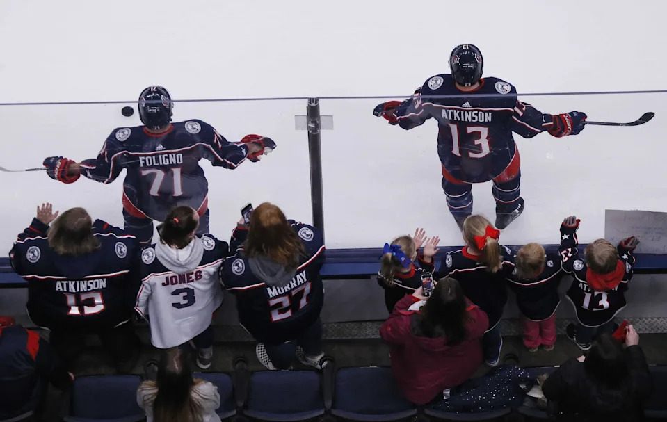 Fans gather to watch Nick Foligno and Cam Atkinson warm up before a game in Nationwide Arena on Jan. 18.