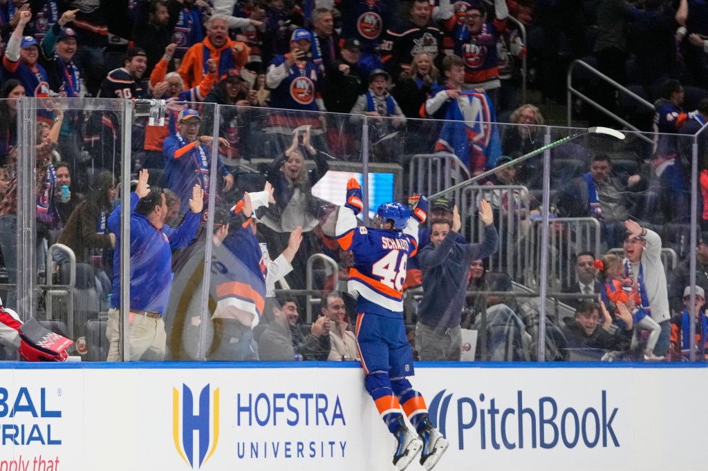 New York Islanders' Matthew Schaefer (48) celebrates his first NHL goal with fans.