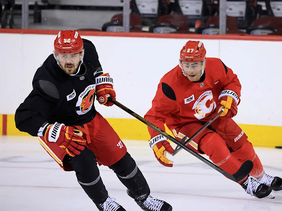  Calgary Flames defenceman MacKenzie Weegar and forward Matt Coronato doing drills during the first day of training camp at the Scotiabank Saddledome on Thursday, Sept. 18, 2025.
