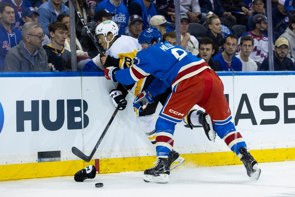 New York Rangers center J.T. Miller (8) checks Pittsburgh Penguins defenseman Caleb Jones (82) against the boards.J.T. Miller (8) checks Pittsburgh Penguins defenseman Caleb Jones (82) in the first period at Madison Square Garden, Tuesday, Oct. 7, 2025, in New York, NY.