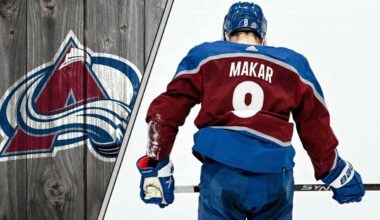 Colorado Avalanche defenseman Cale Makar skates with the puck during an NHL game, poised to make a play.