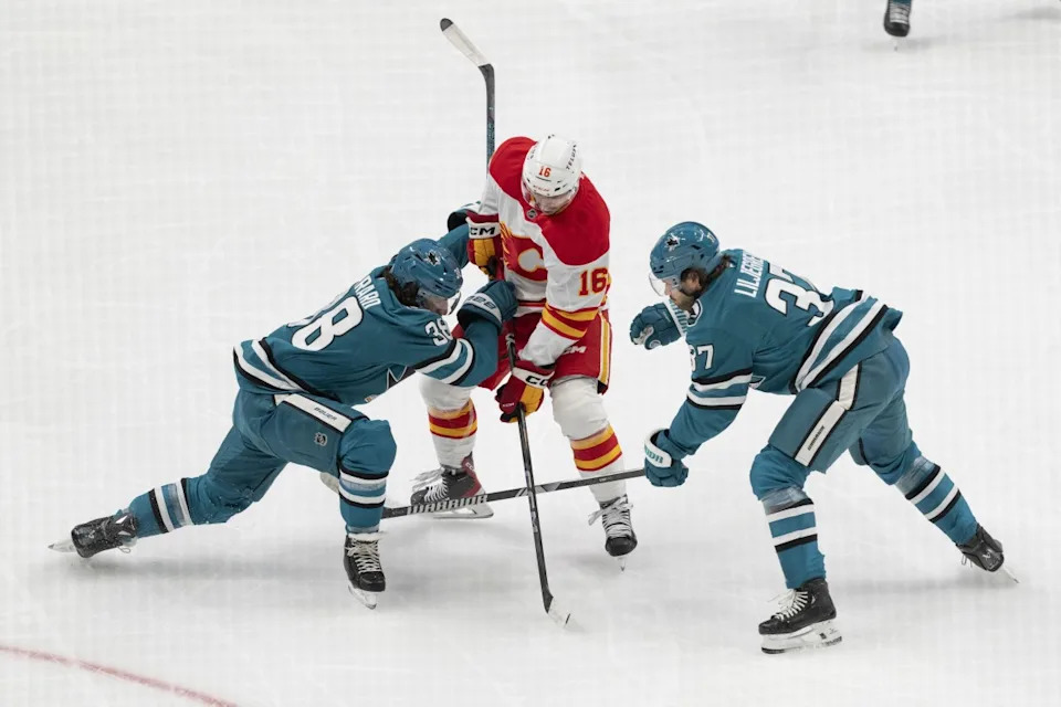 San Jose Sharks defenseman Mario Ferraro (38) and defenseman Timothy Liljegren (37) collide into Calgary Flames center Morgan Frost (16) during the first period at SAP Center at San Jose.