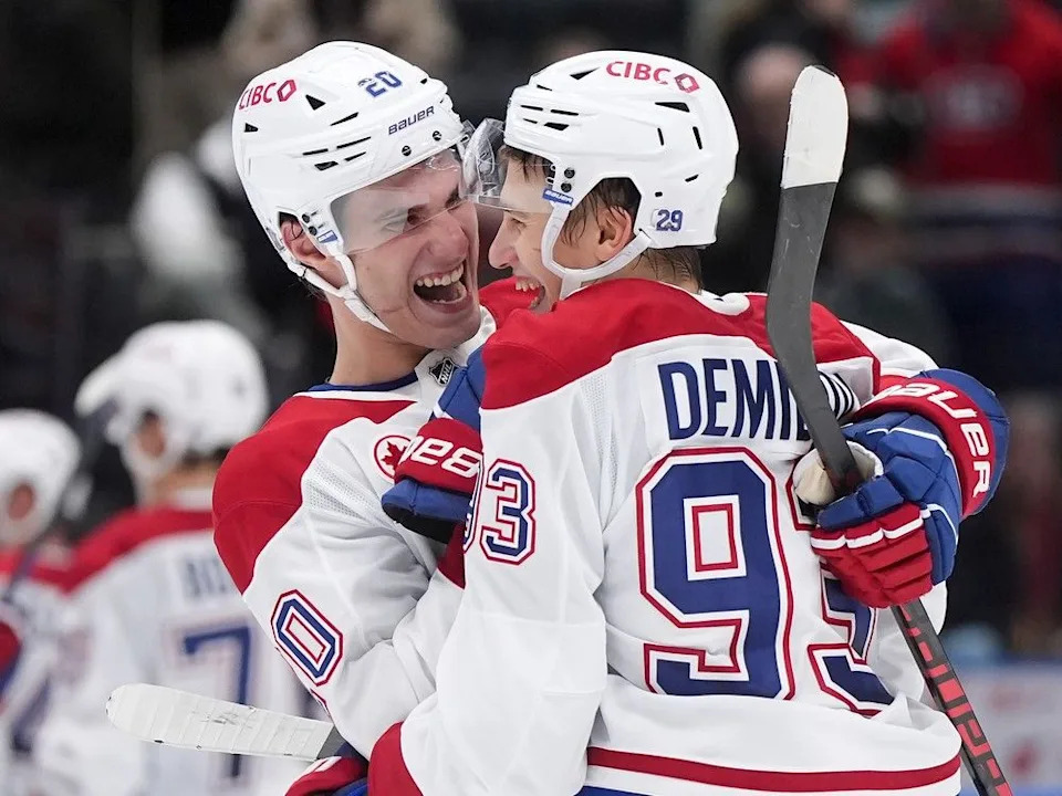  Canadiens’ Juraj Slafkovsky (20) and Ivan Demidov (93) celebrate after Montreal defeated the Canucks 4-3 in Vancouver on Saturday, Oct. 25, 2025.