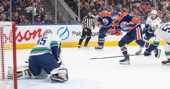Oilers net first win via 3-1 decision over Canucks
