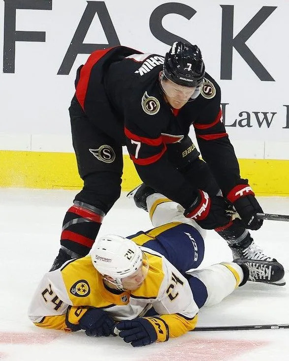  Brady Tkachuk of the Ottawa Senators hits Spencer Stastney from the Nashville Predators during first-period action at the Canadian Tire Centre on Monday.