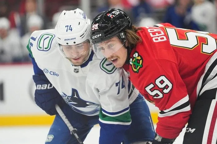  Vancouver Canucks left wing Jake DeBrusk left, and Chicago Blackhawks left wing Tyler Bertuzzi face off Friday.