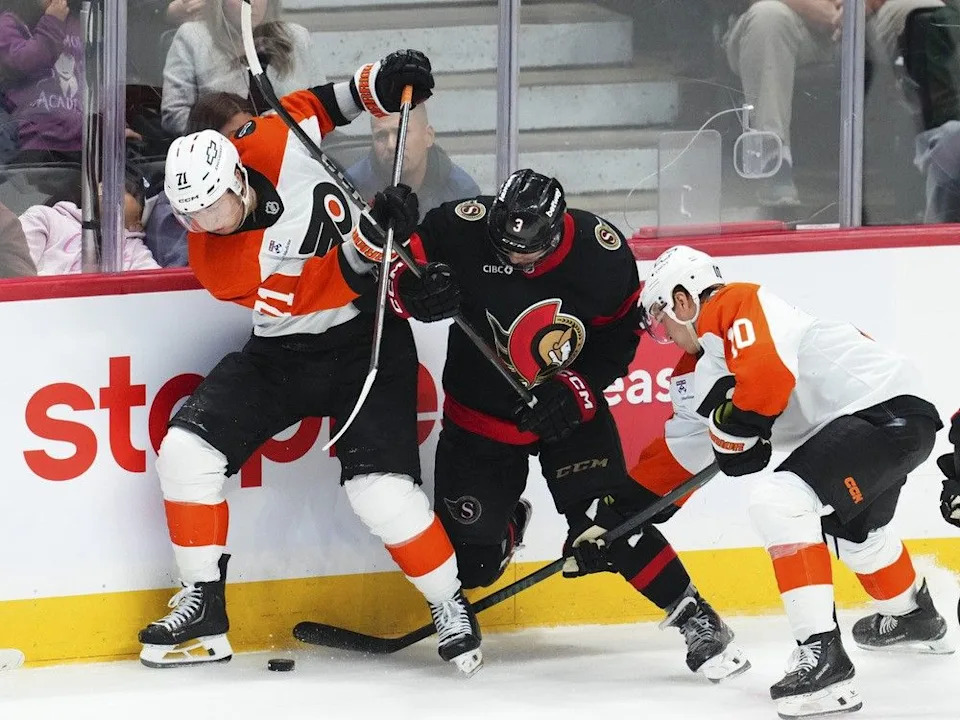 Senators defenceman Nick Jensen, middle, battles for the puck with the Flyers’ Tyson Foerster and Bobby Brink in the third period of Thursday’s game at Canadian Tire Centre.