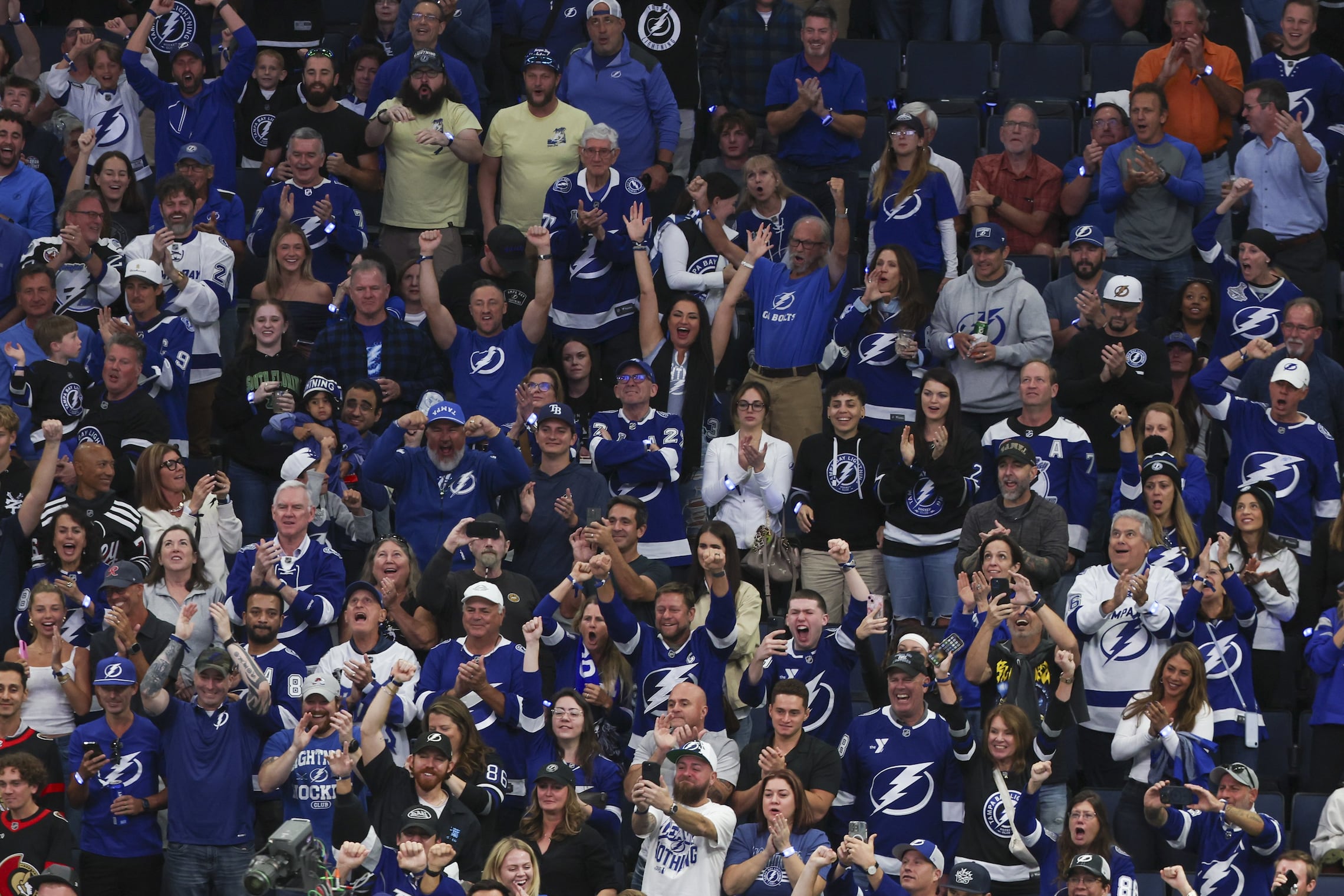 Fans cheer during a fight between Tampa Bay Lightning center Curtis Douglas (42) and Ottawa Senators left wing Kurtis MacDermid (23) during the first period on Thursday, Oct. 9, 2025 in Tampa.