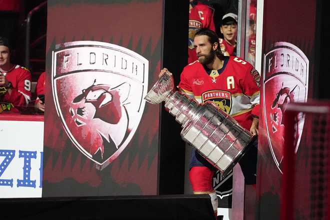 SUNRISE, FL - OCTOBER 07: Florida Panthers defenseman Aaron Ekblad (5) take the ice with th eStanley Cup before the game between the Chicago Blackhawks and the Florida Panthers on Tuesday, October 7, 2025 at Amerant Bank Arena in Sunrise, FL. (Photo by Peter Joneleit/Icon Sportswire via Getty Images)