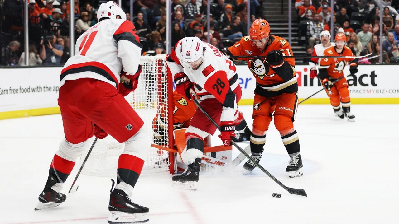 Carolina Hurricanes left wing William Carrier (28) attempts to score against Anaheim Ducks goaltender Lukas Dostal (1) during the second period of an NHL hockey game Thursday, Oct. 16, 2025, in Anaheim, Calif. (AP Photo/Ethan Swope)