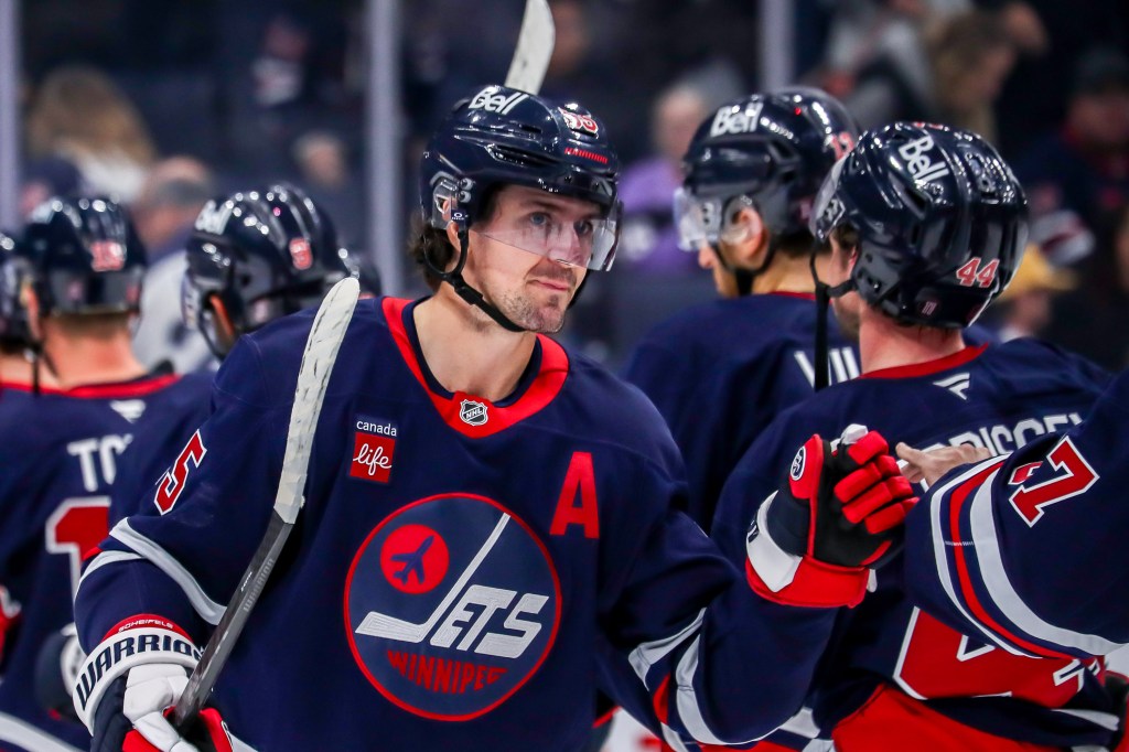 Mark Scheifele of the Winnipeg Jets celebrates with teammates after a victory.