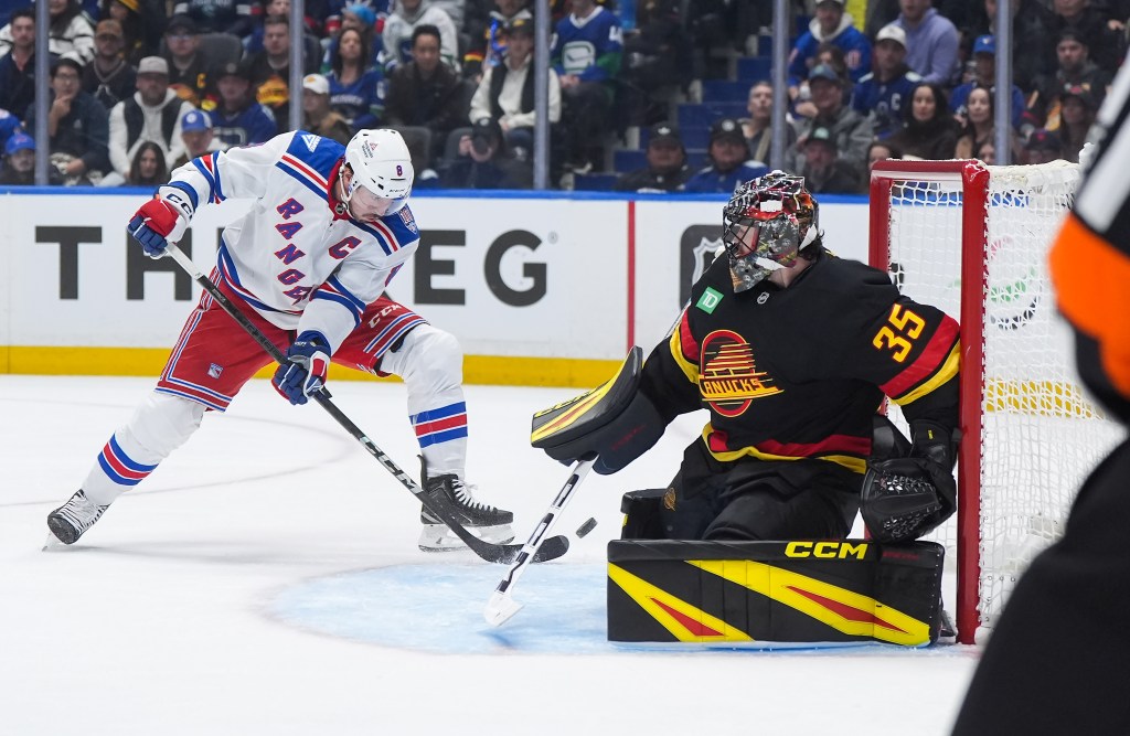 New York Rangers' J.T. Miller misses the open net behind Vancouver Canucks goalie Thatcher Demko.