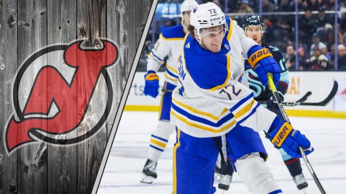 Buffalo Sabres forward Tage Thompson skates with the puck during an NHL game, with the New Jersey Devils logo in the background.