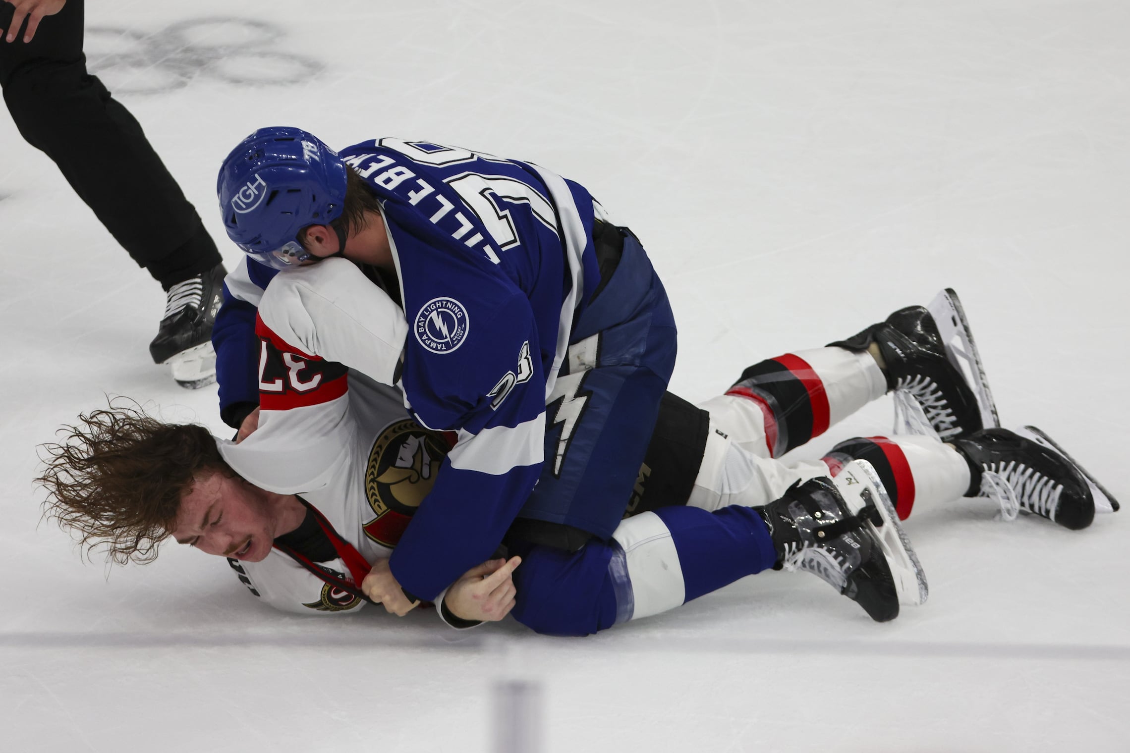 Tampa Bay Lightning defenseman Emil Lilleberg (78) and Ottawa Senators defenseman Donovan Sebrango (37) fight in the first period  on Thursday, Oct. 9, 2025 in Tampa.