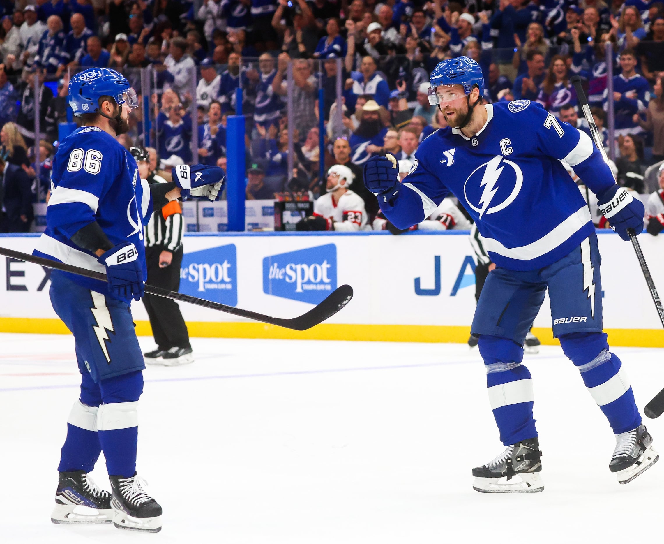 Tampa Bay Lightning right wing Nikita Kucherov (86), left, celebrates his power play goal along with defenseman Victor Hedman (77) after beating Ottawa Senators goaltender Linus Ullmark (35) for the Lightning’s third goal of the game during first period action of the Lightning season opener at Benchmark International Arena on Thursday, Oct. 9, 2025 in Tampa.