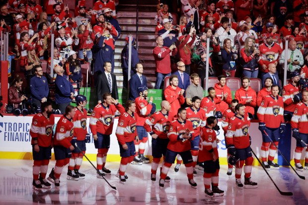 The team watches the 2025 Championship banner as it is...
