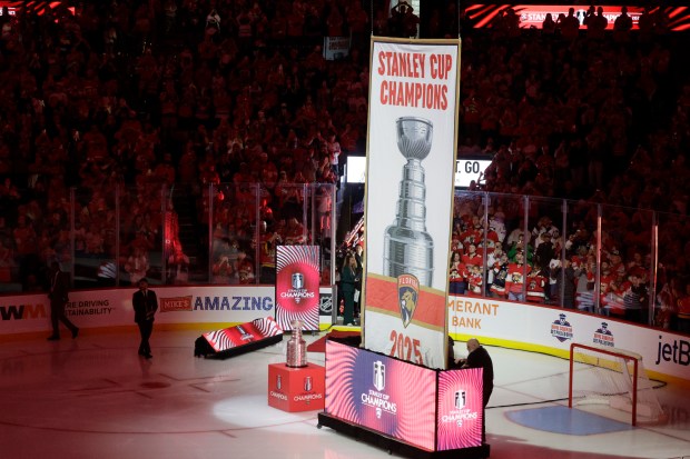 The 2025 Championship banner is raised before the start of...