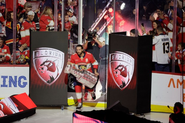 Aaron Ekblad brings the Stanley Cup onto the ice before...