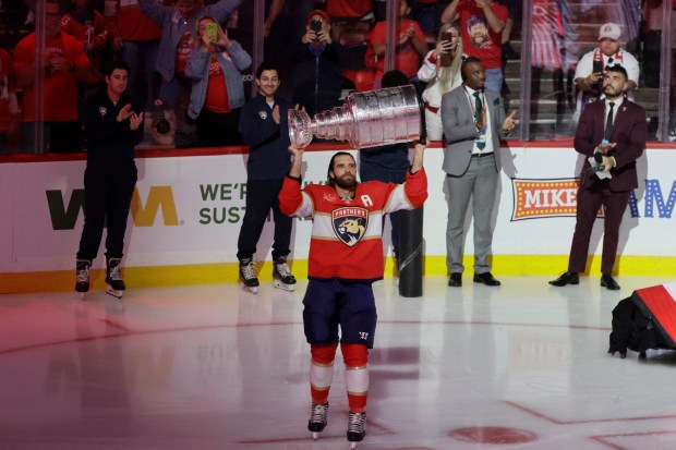 Aaron Ekblad brings the Stanley Cup onto the ice before...