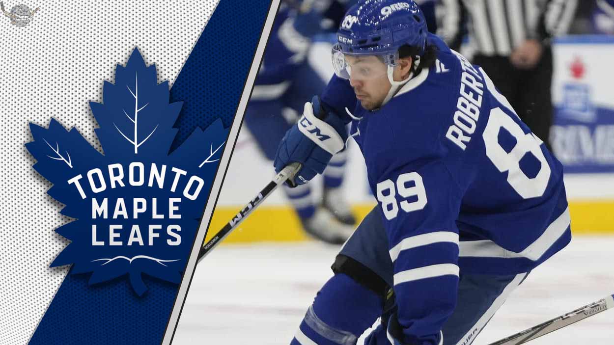 Toronto Maple Leafs forward Nick Robertson skates with the puck during an NHL game.