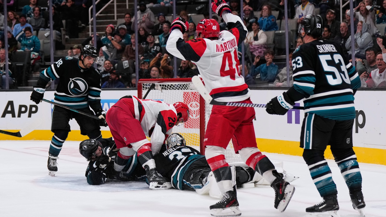 Carrier, Robinson score late in 2nd period and Hurricanes beat Sharks 5-1 to improve to 3-0
