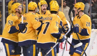 Oct 28, 2025; Nashville, Tennessee, USA;  Nashville Predators left wing Filip Forsberg (9) celebrates with his teammates after scoring a goal against the Tampa Bay Lightning during the third period at Bridgestone Arena. Mandatory Credit: Steve Roberts-Imagn Images
