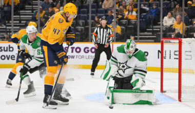 Oct 26, 2025; Nashville, Tennessee, USA;  Dallas Stars goaltender Casey Desmith (1) blocks the shot of Nashville Predators right wing Michael McCarron (47) during the third period at Bridgestone Arena. Mandatory Credit: Steve Roberts-Imagn Images
