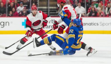 Nov 8, 2025; Raleigh, North Carolina, USA;  Carolina Hurricanes defenseman K'Andre Miller (19) checks Buffalo Sabres center Tage Thompson (72) during the third period at Lenovo Center. Mandatory Credit: James Guillory-Imagn Images