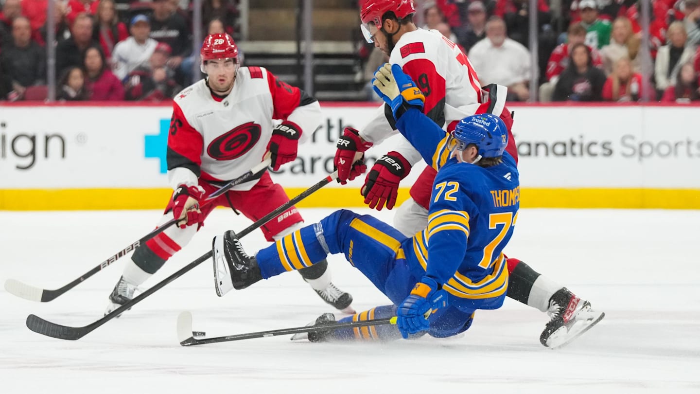Nov 8, 2025; Raleigh, North Carolina, USA;  Carolina Hurricanes defenseman K'Andre Miller (19) checks Buffalo Sabres center Tage Thompson (72) during the third period at Lenovo Center. Mandatory Credit: James Guillory-Imagn Images
