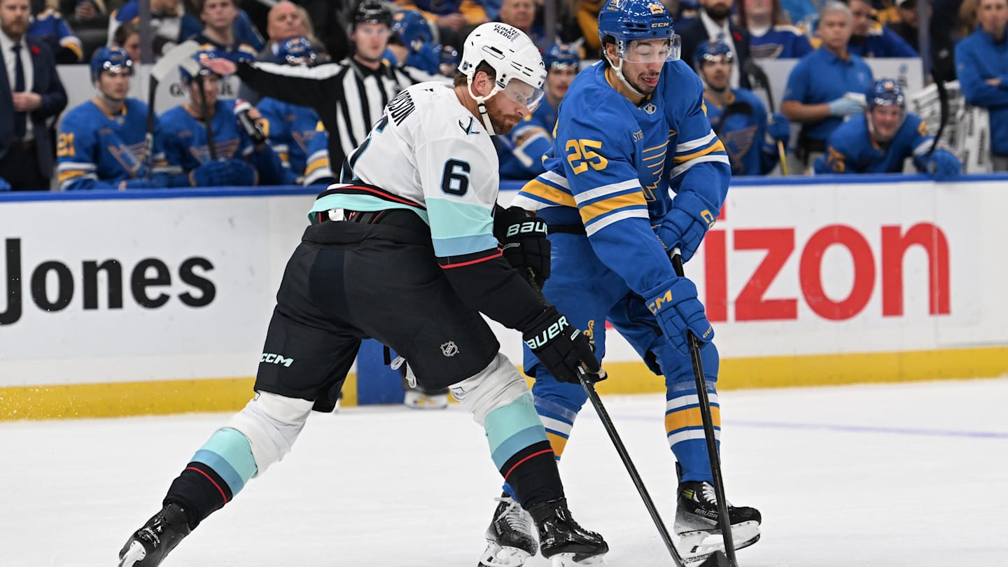 Nov 8, 2025; St. Louis, Missouri, USA; Seattle Kraken defenseman Adam Larsson (6) and St. Louis Blues right wing Jordan Kyrou (25) battle for the puck in the second period at Enterprise Center. Mandatory Credit: Joe Puetz-Imagn Images