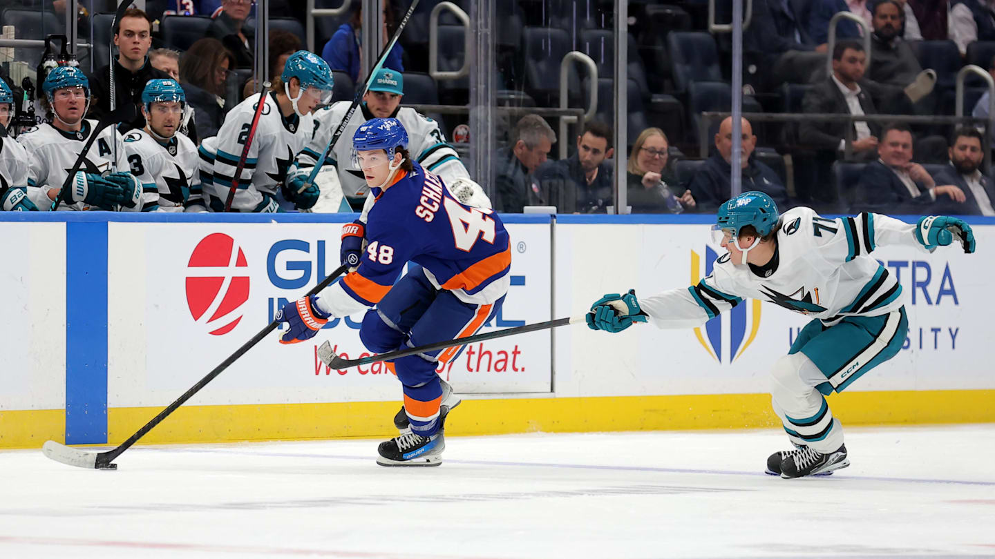 Oct 21, 2025; Elmont, New York, USA; New York Islanders defenseman Matthew Schaefer (48) skates with the puck against San Jose Sharks center Macklin Celebrini (71) during the second period at UBS Arena. Mandatory Credit: Brad Penner-Imagn Images