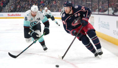 Blue Jackets forward Mathieu Olivier works against Kraken defenseman Adam Larsson.