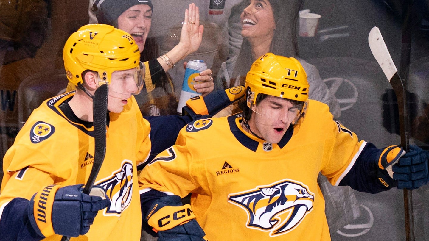 Nashville right wing Matthew Wood (71) and right wing Luke Evangelista (77) celebrate Evangelista’s first goal of the year against Tampa Bay during their game at Bridgestone Arena in Nashville, Tenn., Tuesday, Oct. 28, 2025.