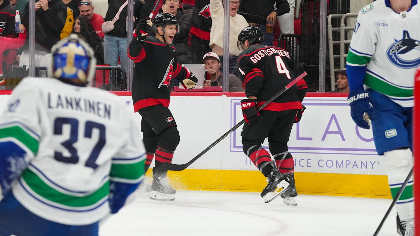 Nov 14, 2025; Raleigh, North Carolina, USA;  Carolina Hurricanes left wing Taylor Hall (71) celebrates his goal with  defenseman Shayne Gostisbehere (4) against the Vancouver Canucks during the third period at Lenovo Center. Mandatory Credit: James Guillory-Imagn Images