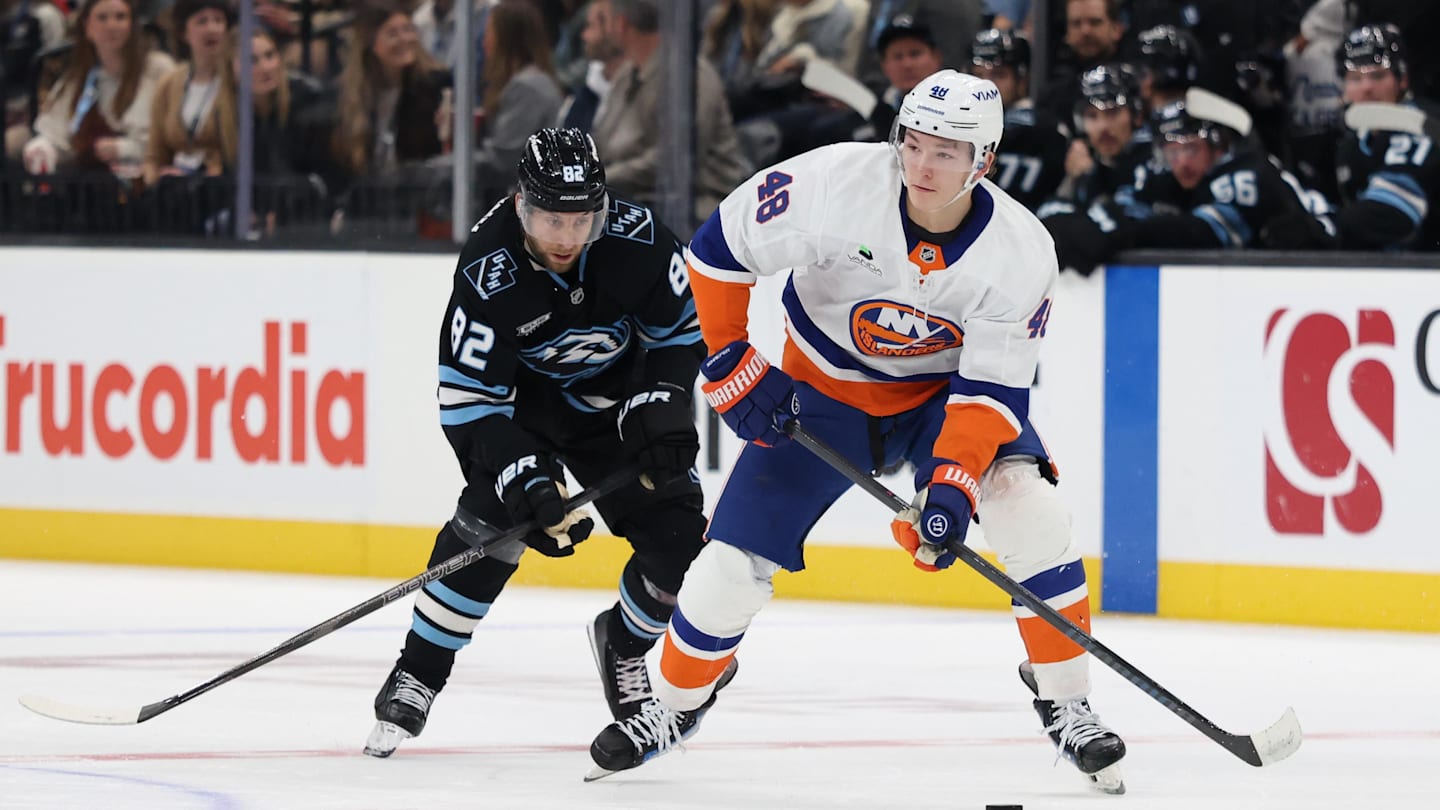 Nov 14, 2025; Salt Lake City, Utah, USA; New York Islanders defenseman Matthew Schaefer (48) skates with the puck against Utah Mammoth center Logan Cooley (92) during the second period at Delta Center. Mandatory Credit: Rob Gray-Imagn Images