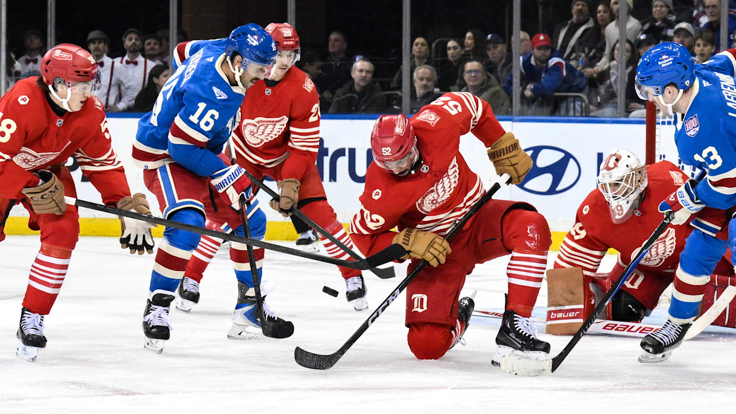 Nov 16, 2025; New York, New York, USA; Detroit Red Wings defenseman Travis Hamonic (52) tries to gain control of the puck against New York Rangers center Vincent Trocheck (16) during the third period at Madison Square Garden. Mandatory Credit: John Jones-Imagn Images