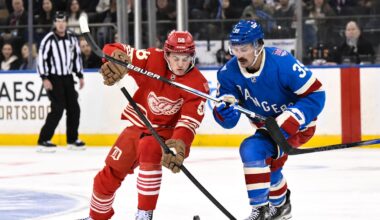Nov 16, 2025; New York, New York, USA; Detroit Red Wings center Emmitt Finnie (58) and New York Rangers center Sam Carrick (39) compete for the puck during the second period at Madison Square Garden. Mandatory Credit: John Jones-Imagn Images