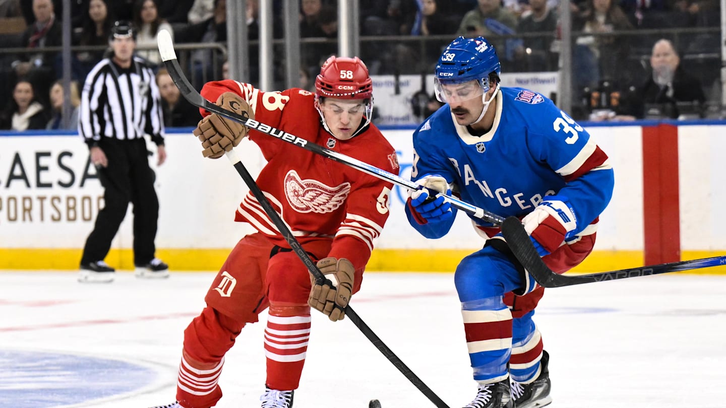 Nov 16, 2025; New York, New York, USA; Detroit Red Wings center Emmitt Finnie (58) and New York Rangers center Sam Carrick (39) compete for the puck during the second period at Madison Square Garden. Mandatory Credit: John Jones-Imagn Images