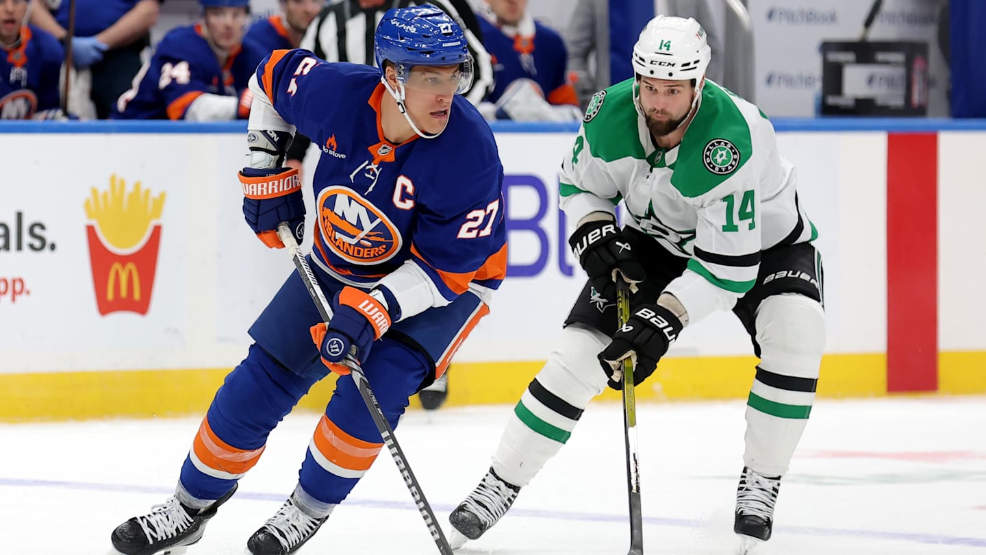 Feb 23, 2025; Elmont, New York, USA; New York Islanders left wing Anders Lee (27) skates with the puck against Dallas Stars left wing Jamie Benn (14) during the second period at UBS Arena. Mandatory Credit: Brad Penner-Imagn Images