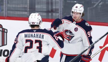 Blue Jackets forwards Sean Monahan and Kent Johnson celebrate a goal. Now full-time linemates, they need some help.