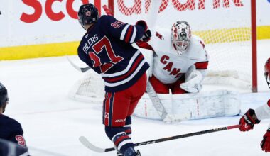 Feb 4, 2025; Winnipeg, Manitoba, CAN;  Carolina Hurricanes goalie Pyotr Kocketkov (52) makes a save on a shot by Winnipeg Jets forward Nikolaj Ehlers (27) during the third period at Canada Life Centre. Mandatory Credit: Terrence Lee-Imagn Images